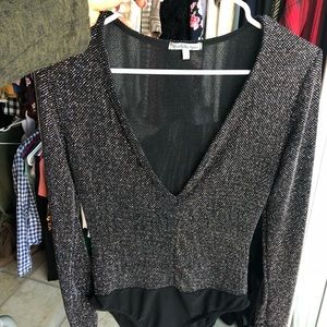 Low V neck body suite , with cute shimmer patter .